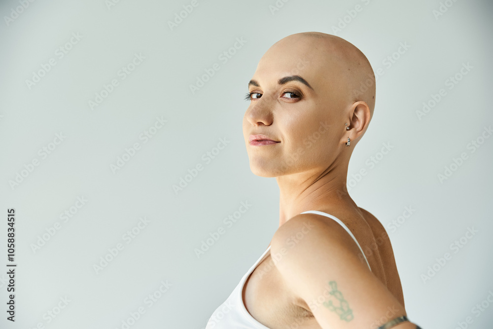 A young bald woman showcases her natural beauty with a confident expression and a gentle pose. A young bald woman showcases her natural beauty with a confident expression and a gentle pose.