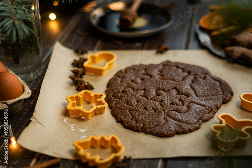 Making Christmas cookies. Rolled dough and cookie cutters on table. photo