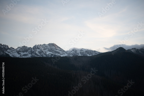 The sunset atop Mount Kopieniec in Zakopane, Poland, casts a warm glow over the Tatra Mountains