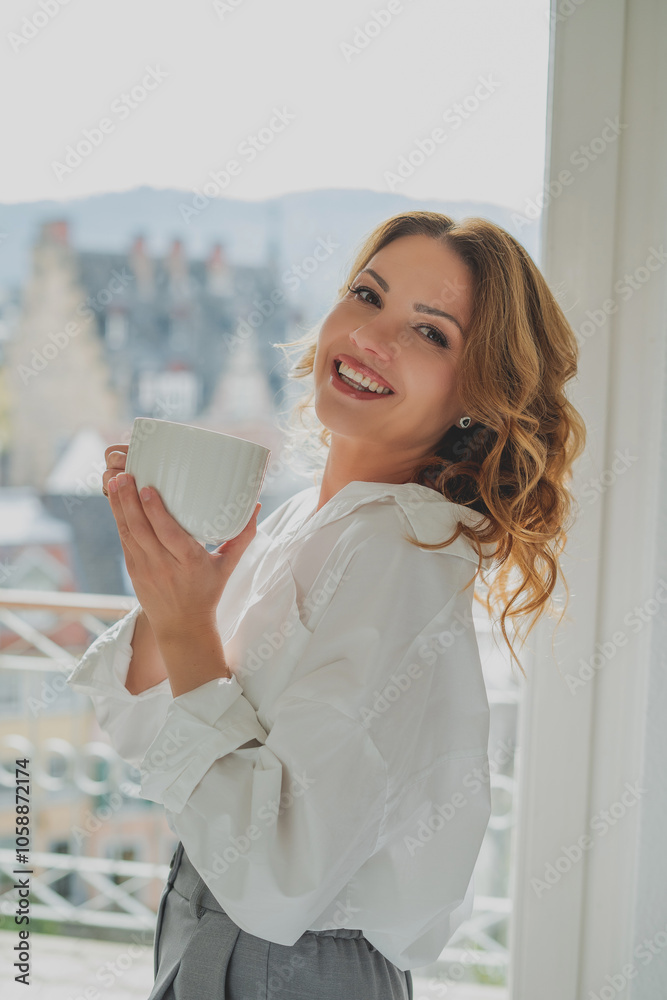 Portrait of beautiful young woman, 42 years old, with cup of hot tea by the window. Warm, cozy home. Portrait of beautiful young woman, 42 years old, with cup of hot tea by the window. Warm, cozy home.