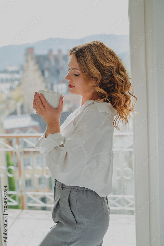 Portrait of beautiful young woman, 42 years old, with cup of hot tea by the window. Warm, cozy home. Portrait of beautiful young woman, 42 years old, with cup of hot tea by the window. Warm, cozy home.