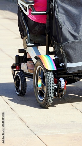 Winter Pride Maspalomas. Wheelchair painted with the colors of the rainbow flag, symbol of the LGBTQ community, in the gay resort of Playa del Ingles in the tourist village of Maspalomas