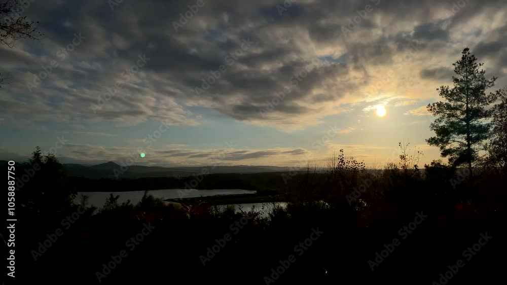 a beautiful sunset by a mountain lake. autumn sunset
