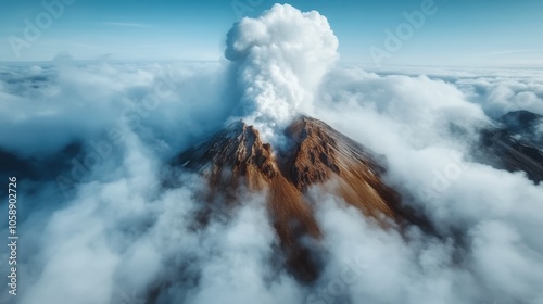 A majestic volcano actively erupts, releasing thick clouds of smoke that swirl around the craggy peak, showcasing nature's raw power and beauty from a dramatic aerial view. photo