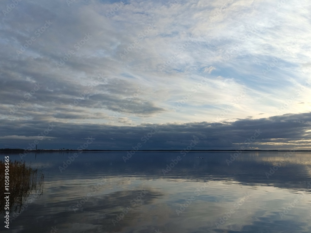 Rekyva lake during sunny day. Sunny day with white and gray clouds in blue sky. Wavy lake. Horizon over water. Rekyvos ezeras.	