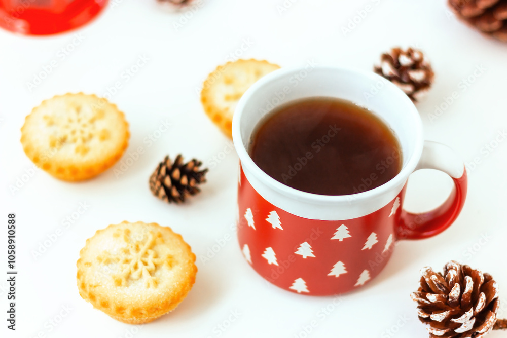 red mug with white fir trees and cakes with snowflake and pine cone red mug with white fir trees and cakes with snowflake and pine cone