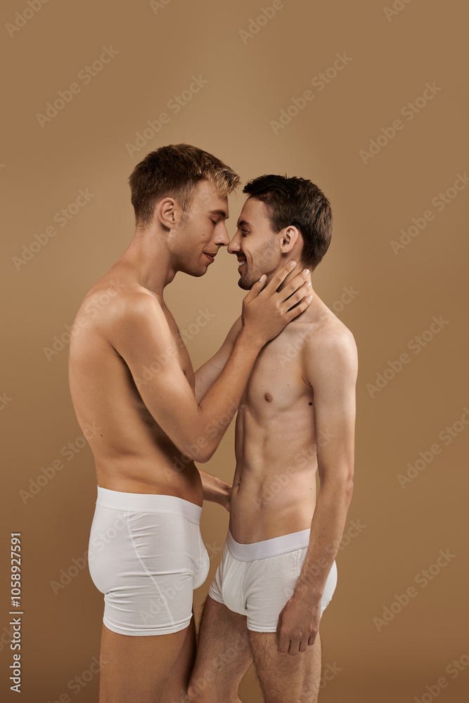 Two young men gaze into each others eyes, embracing affection in a cozy setting. Two young men gaze into each others eyes, embracing affection in a cozy setting.