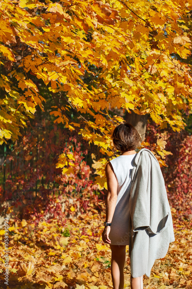 Portrait of a girl against a background of yellow trees, the girl is standing with her back Portrait of a girl against a background of yellow trees, the girl is standing with her back