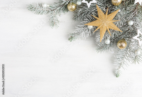 Fir branch with white and gold  Christmas decorations on old wooden shabby background with empty space for text. Flat lay