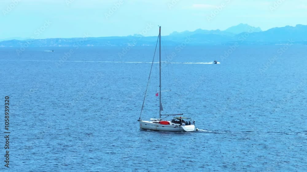 Tranquil sailing journey on a clear blue lake with distant mountains in the background during a sunny afternoon Tranquil sailing journey on a clear blue lake with distant mountains in the background during a sunny afternoon