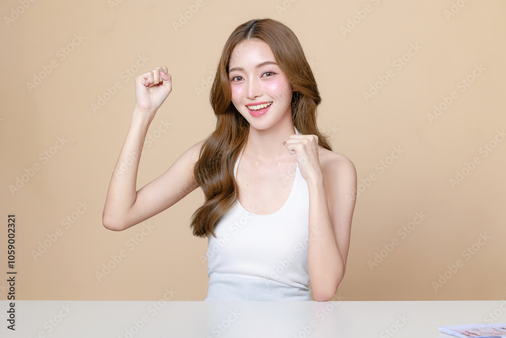Young Asian beauty woman curly long hair with korean makeup style touch her face and perfect skin on isolated beige background. Facial treatment, Cosmetology, plastic surgery.