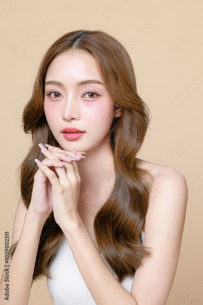 Young Asian beauty woman curly long hair with korean makeup style touch her face and perfect skin on isolated beige background. Facial treatment, Cosmetology, plastic surgery. Young Asian beauty woman curly long hair with korean makeup style touch her face and perfect skin on isolated beige background. Facial treatment, Cosmetology, plastic surgery.
