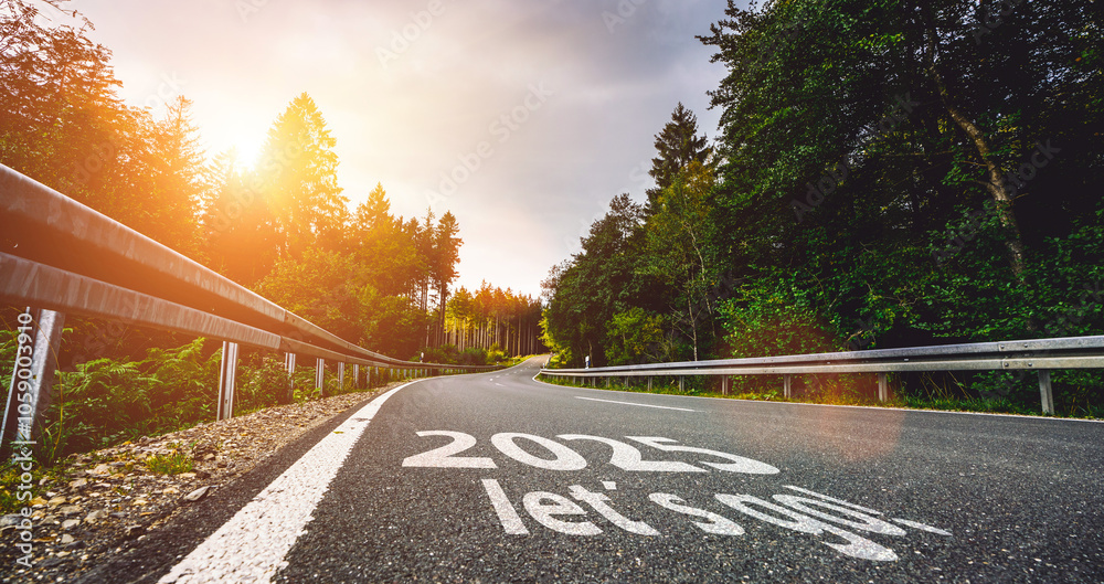 New year 2025 or start straight and beginning concept. Man ride on bike and the number 2025 start written on the road at sunset with lens flare. Concept of challenge or career path, business strategy.