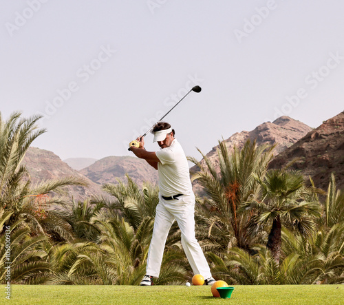 The golfer hits the golf ball with the Drive in his hand, on the tee.