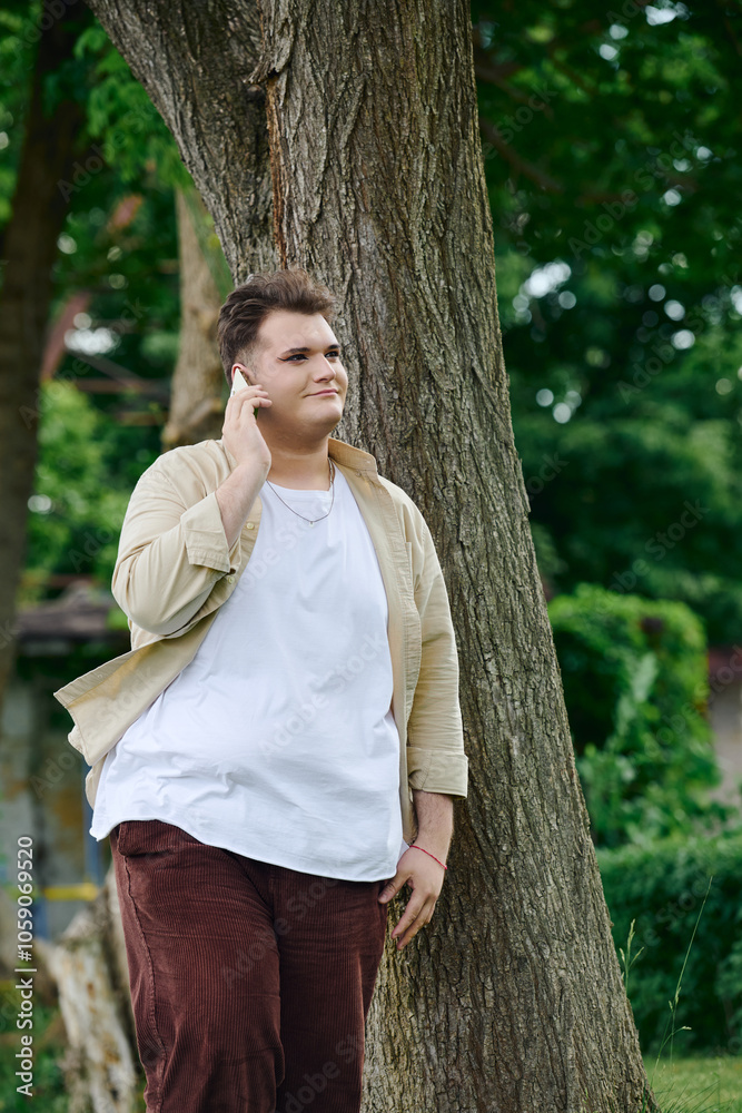 Standing under a large tree, a queer individual enjoys a quiet moment lost in music and reflection. Standing under a large tree, a queer individual enjoys a quiet moment lost in music and reflection.