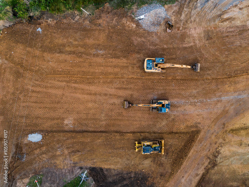 Aerial view of three earthmoving machinery on construction site for Singleton Bypass photo