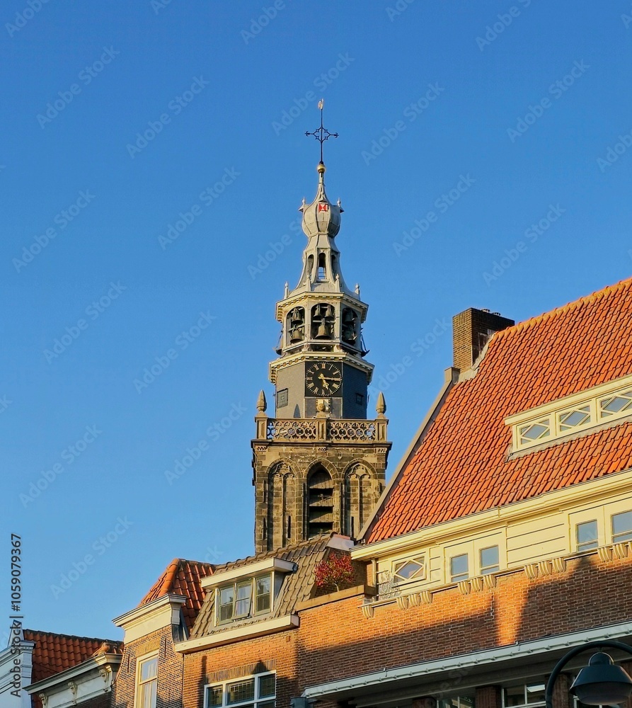 Fototapeta premium City view of Gouda in the Netherlands, with a church and some buildings in the foreground.