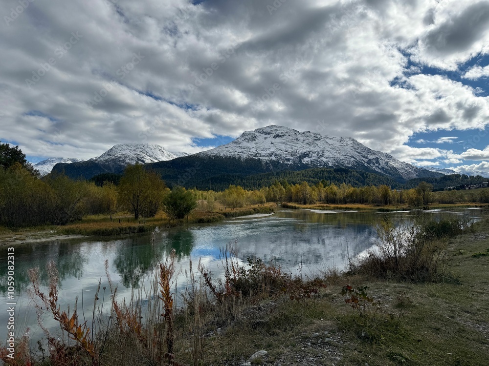 Serene landscape with snow-capped mountains reflected in a tranquil lake in Samedan, Switzerland Serene landscape with snow-capped mountains reflected in a tranquil lake in Samedan, Switzerland