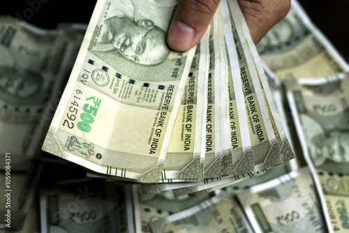 A man hand holding Indian 500 Rupees bank note