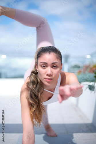 A young woman doing a yoga workout at the rooftop photo