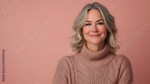 Beloved Children s Author Smiles Warmly and Invitingly in a Cozy Cable Knit Sweater Against a Plain Dusty Rose Background Exuding Confidence and Approachability in This Uplifting Portrait