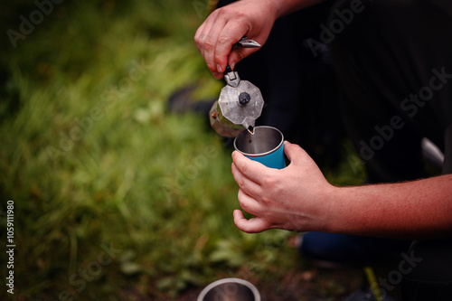 Pouring Fresh Coffee from Moka Pot into Cup Outdoors