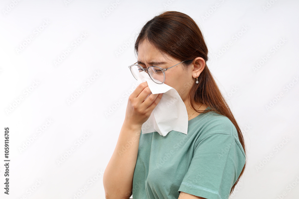 Portrait of beautiful young asian sick woman being wrapped in scarf sneezing, suffering from runny nose and high temperature. Cold and fever concept. Portrait of beautiful young asian sick woman being wrapped in scarf sneezing, suffering from runny nose and high temperature. Cold and fever concept.