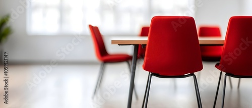 Sleek and Bright Corporate Meeting Room with Contemporary Furnishings and Decor  Executives Seated Around a Table in a Modern Office Setting with Large Windows Providing Natural Light