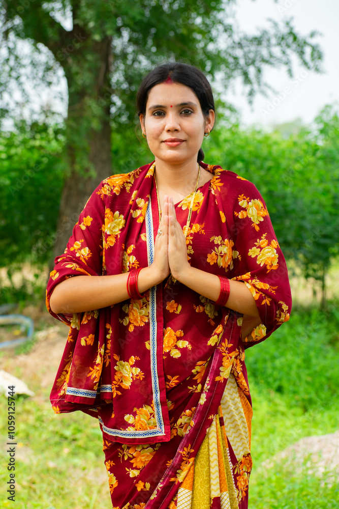 Happy indian village woman in saree showing namaste gesture Happy indian village woman in saree showing namaste gesture