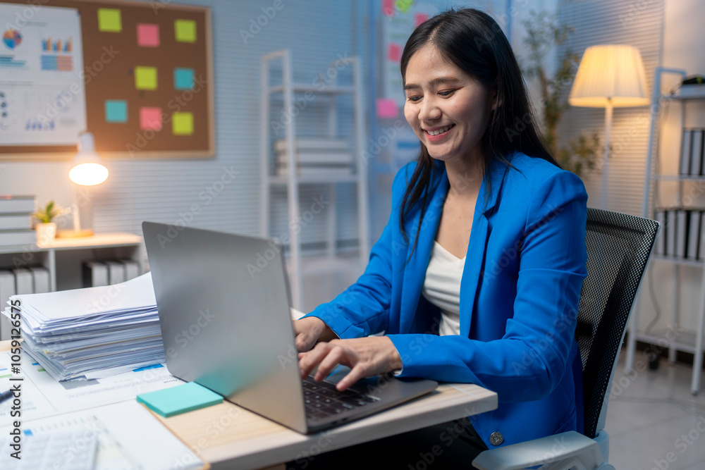 A woman is sitting at a desk with a laptop in front of her A woman is sitting at a desk with a laptop in front of her