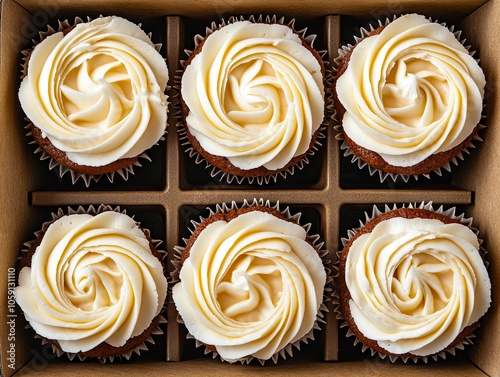 A box of cupcakes with white frosting in it