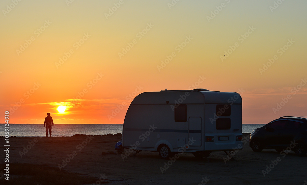 Camper see the sunrise on the beach and camping car Camper see the sunrise on the beach and camping car