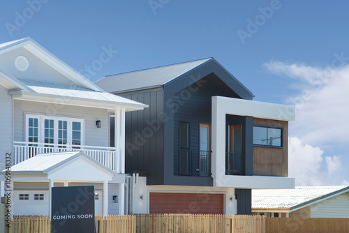 two storey design of a modern house with coming soon sign photo