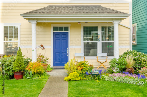 Entrance of grey painted luxury house in summer with stair steps and nice landscape in Vancouver, Canada, North America. Day time on June 2024