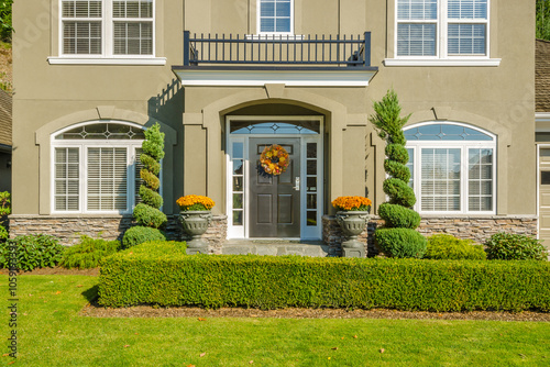 Entrance of grey painted luxury house in summer with stair steps and nice landscape in Vancouver, Canada, North America. Day time on June 2024 photo