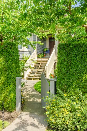 Entrance of grey painted luxury house in summer with stair steps and nice landscape in Vancouver, Canada, North America. Day time on June 2024