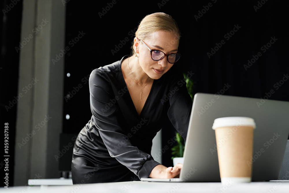 A dedicated young plus size woman is working intently at her laptop in a stylish office environment. A dedicated young plus size woman is working intently at her laptop in a stylish office environment.