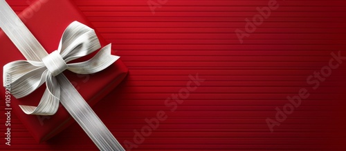 Red Gift Box With Silver Bow on Striped Red Background