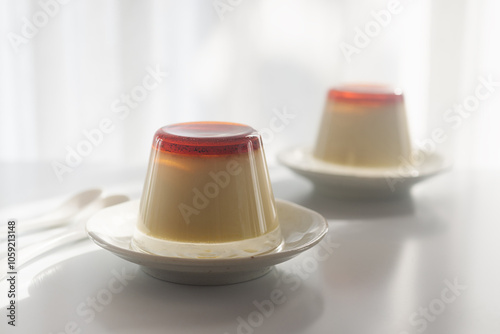 Homemade caramel custard pudding in an upside down glass on a plate, how to unmold caramel pudding. photo