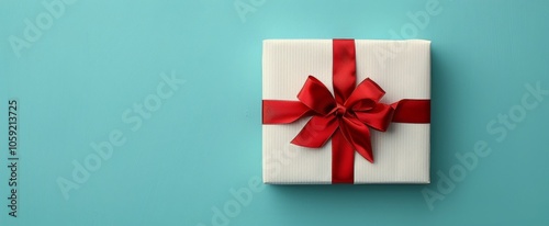 White Gift Box With Red Ribbon on Blue Background