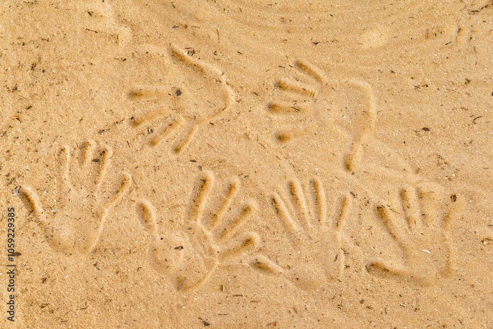 Handprints pressed into the sandy surface. Handprints pressed into the sandy surface.