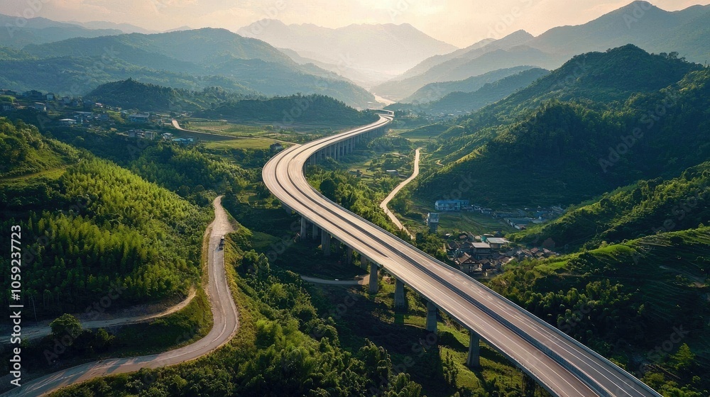 Aerial view of highway road bridge for vehicular transport as part of infrastructure development built over valley with green forest trees Aerial view of highway road bridge for vehicular transport as part of infrastructure development built over valley with green forest trees