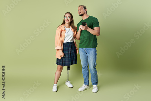 A non binary person and their friend share laughs in a warm, inviting space. photo