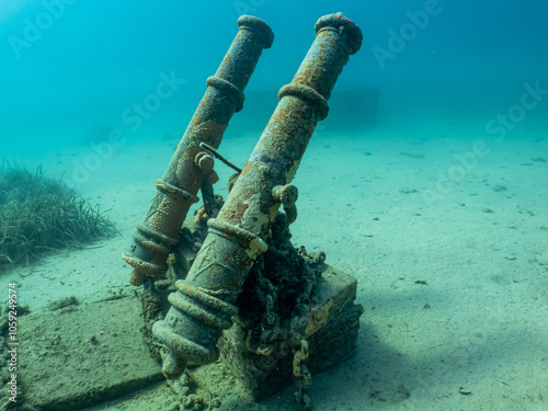 Two old cannons as a part of an artificial reef in the Adriatic Sea. Beautiful turquoise water in Croatia photo