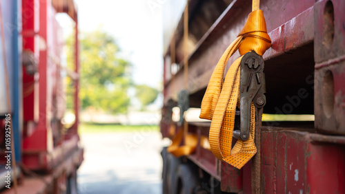 Close-up at locking device of safety latching strap that using for secure equipment or heavy object that transport on trailer truck. Transportation industrial equipment object, selective focus. photo