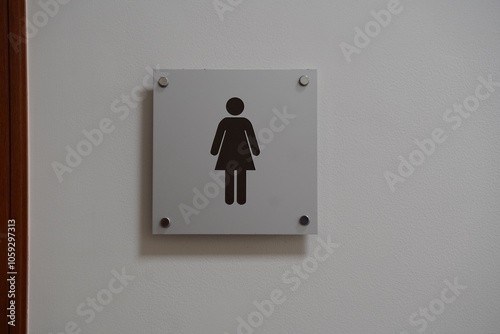 modern public toilet sign on the cement wall
