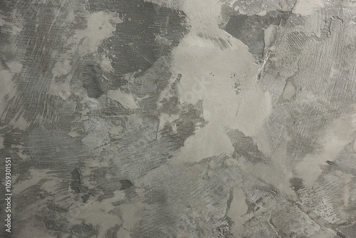 Close-up of microcement texture with various shades of gray and a rough, uneven surface. Ideal for showcasing modern interior design and architectural details.