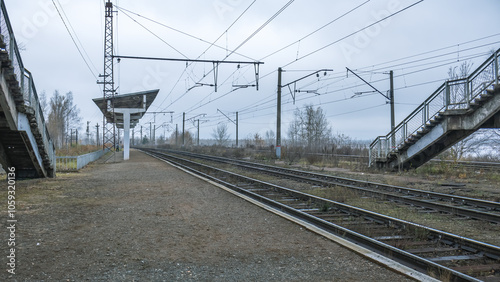 Railway station. The railway tracks pass through a small platform where people can board the carriages. A railway for transporting goods and transporting people.