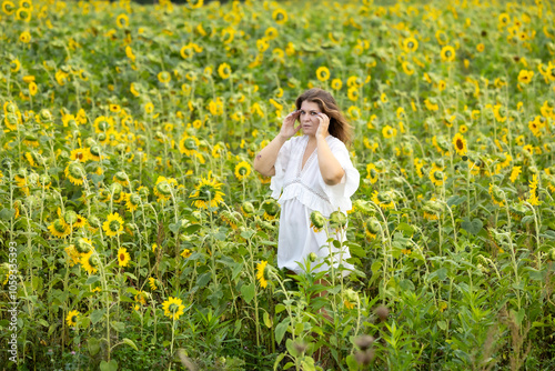 A Woman in White in a Field of Sunflowers: A Moment of Serenity Among Yellow Blossoms