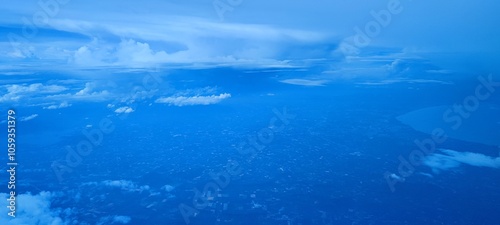 Aerial View of Blue Cloudscape Over Cityscape